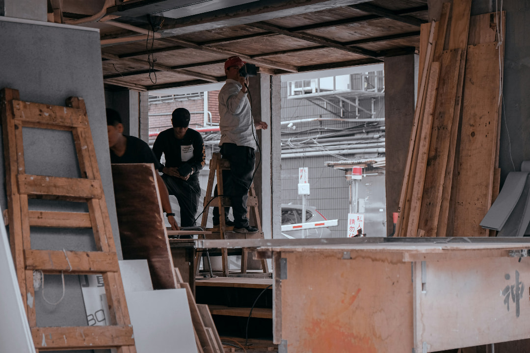 People painting an interior wall during home renovation